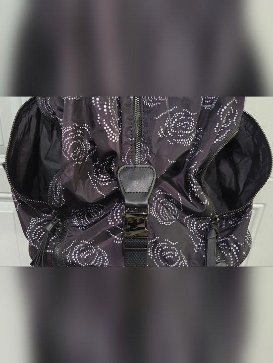 Fabletics The Row Backpack in black with a white digital roses pattern.  main image 6